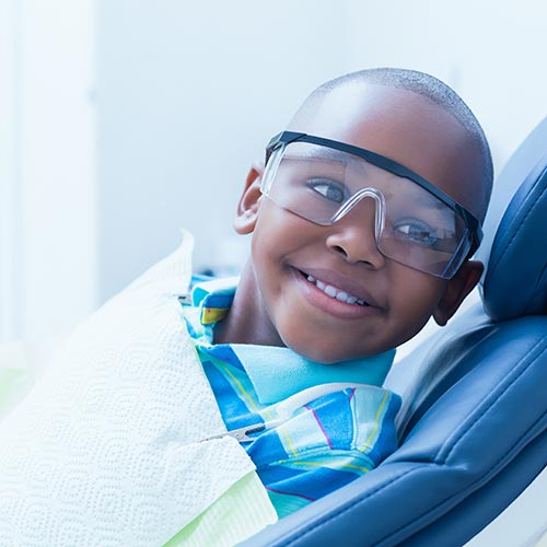 smiling boy waiting for dental exam in Mississauga