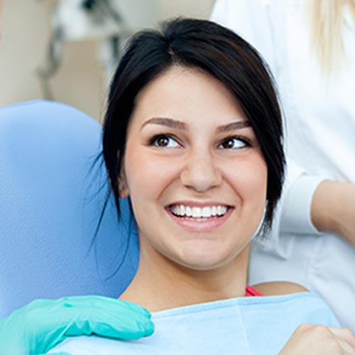 smiling woman at dentist for a dental guard fitting in Mississauga